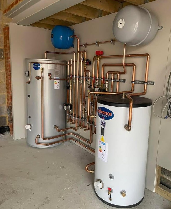 Dual unvented cylinder installation with copper manifold and expansion vessels